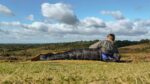 Man in a Criterion 200 Sleeping Bag looking out over a some moor land